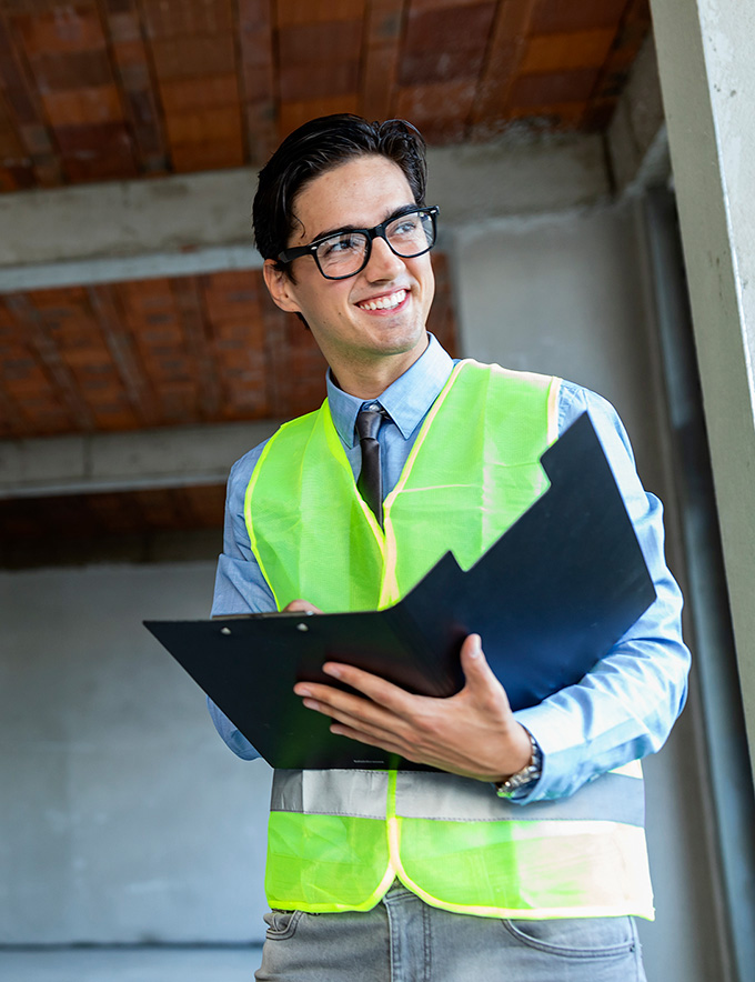 Male civil engineer with a checklist at a job site